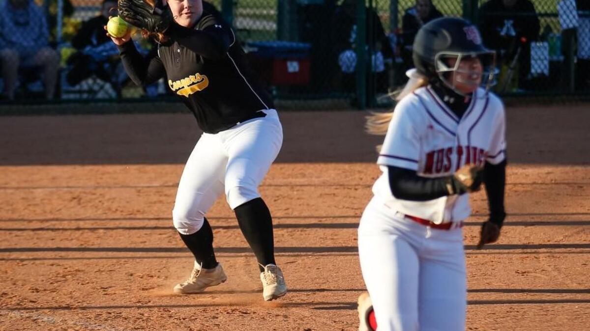 Apex first baseman Olivia Chiarolanzio throws out Middle Creek's Lily Morris after a bunt during Apex's softball match at Middle Creek on Tuesday, April 5, 2016. Apex won the game 14-3.