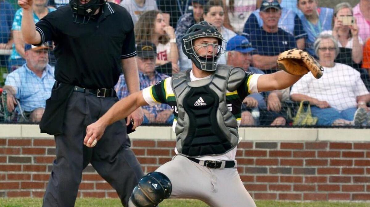 The umpire signals a strike as Bunn's Spencer Brickhouse returns the ball to the mount during the Wildcats' game against South Granville in Bunn, N.C. Tuesday, April 26, 2016.
