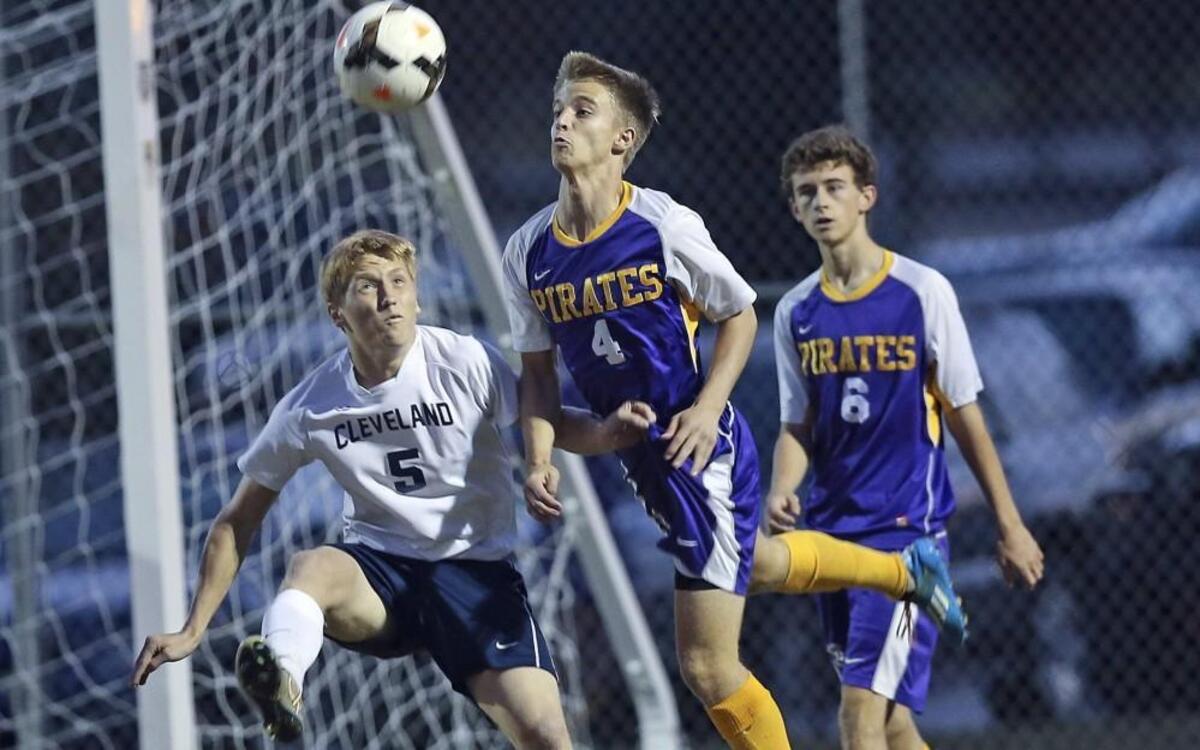 Corinth Holders' Derek Kaple (4) and Cleveland's Tanner Costine (5) battle for the ball as Reis Yu (6) backs up the play. Coverage from the high school soccer game between the Cleveland Rams and the Corinth Holders Pirates played in Clayton, N.C. on Wednesday, October 28, 2015. Cleveland won 2-0.