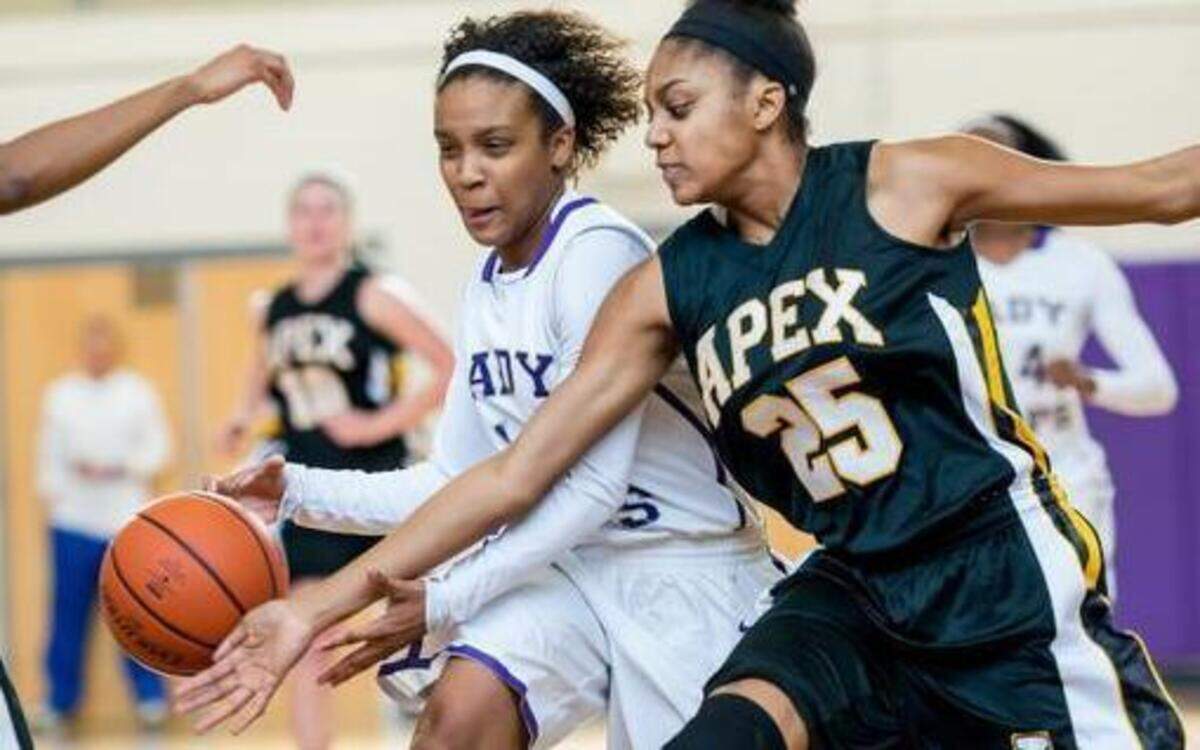 
Broughton's Junior Brittney Smith (15) drives against Apex's Sophomore Samantha Michel (25) during a girls basketball game on Saturday, February 28, 2015 in Raleigh. Broughton Capitals won 67-50.

