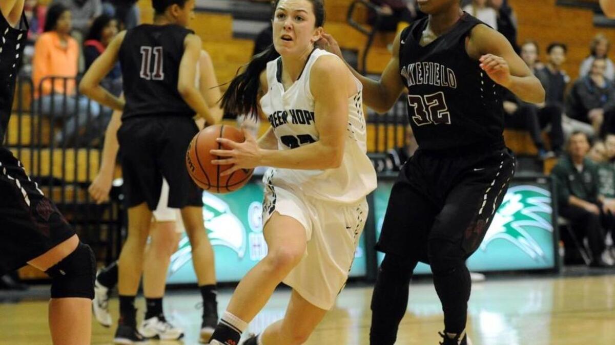 Green Hope's Kelly Fitzgerald (22) drives past Wakefield's Gabby Donaldson (32) during the girls basketball game in the second round of the NCHSAA 4A playoffs, which was played in Cary on Thursday, February 25, 2016. Green Hope won 61-46.