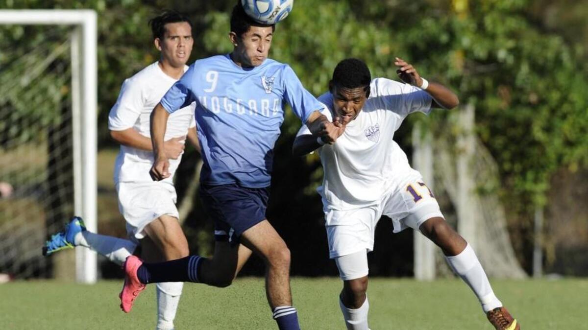 Hoggard's Cesar Cruz (9) heads the ball alongside Broughton's Esteban Salinas Noyola (17) in their 4A playoff game in Raleigh, N.C. on Wednesday, November 11, 2015. Broughton won.