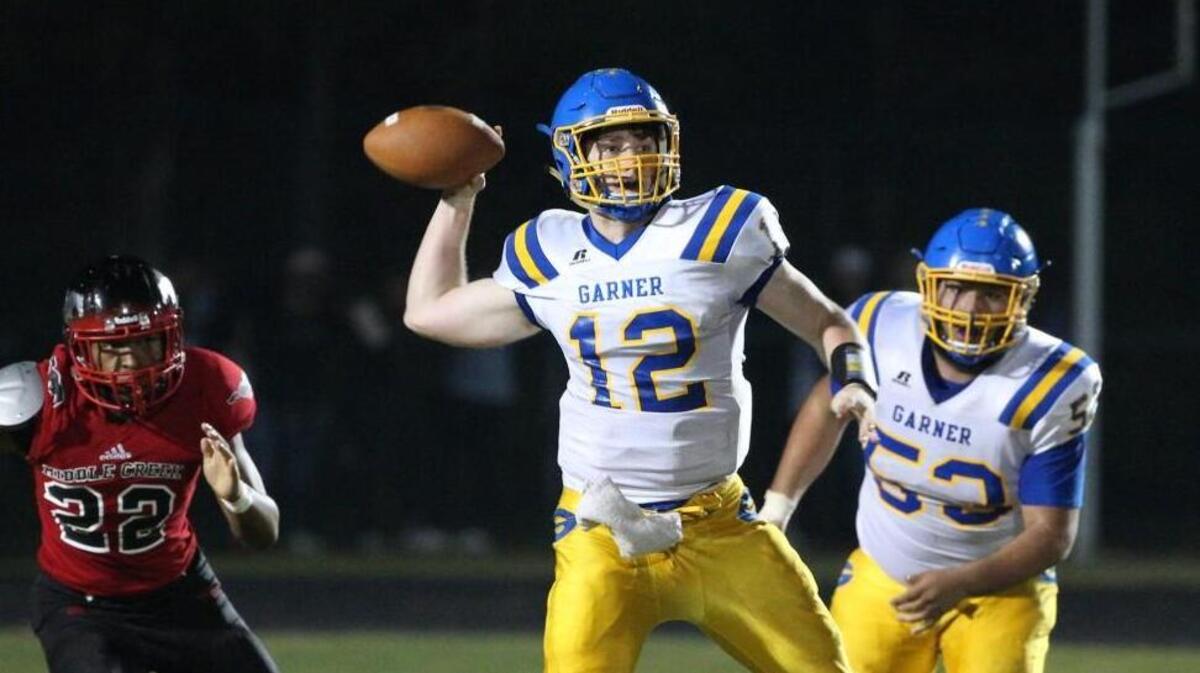 Garner's Nolan McLean (12) looks for a receiver. The Garner Trojans visited the Middle Creek Mustangs in a high school football game on Nov. 3, 2017.