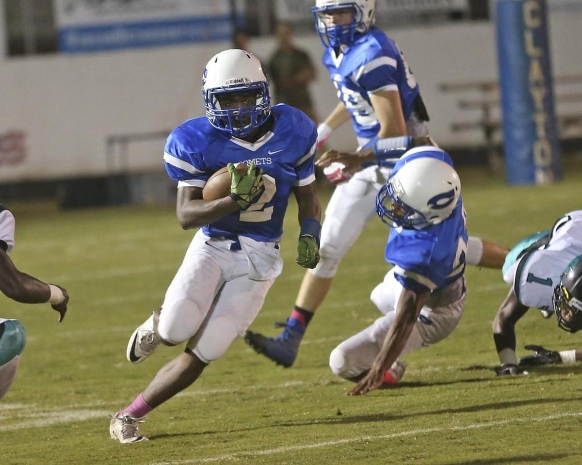 Clayton's Macaleb Robertson (2) runs around end to pick up a few yards against the stingy West Johnston defense. Coverage from the prep football game between the Clayton Comets and West Johnston Wildcats played in Clayton, N.C. on Friday, October 21, 2016. West Johnston defeated Clayton 48-0.