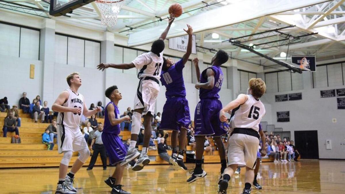 East Chapel Hill's Jonathan Runyambo (20) contests a rebound with Riverside's Isaiah Reddish (10) at East Chapel Hill High School on Friday, January 13, 2017. Special to The Herald-Sun | John Joyner