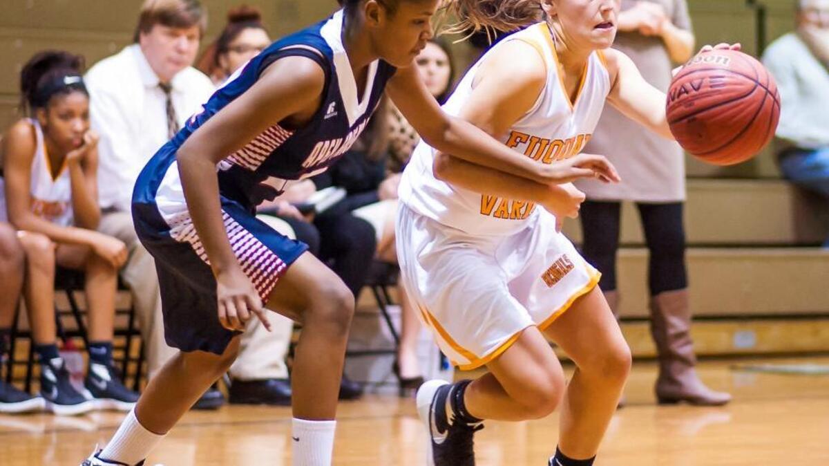 Fuquay Varina's Kelley Suggs (20) drives past Apex Friendship's Camyrn Lunsford (21) during a girls basketball game on Tuesday, December 1, 2015 in Fuquay Varina, N.C.