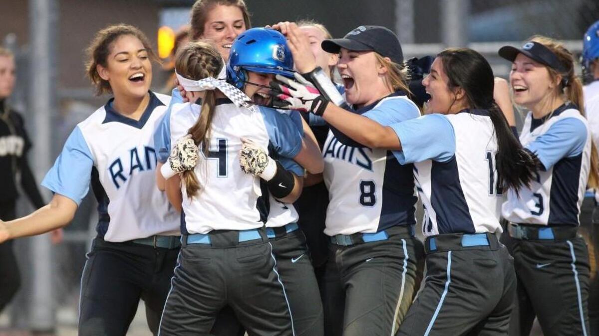 Cleveland’s Ali Papworth, with the helmet, is congratulated by her teammates after game-winning hit Tuesday night against South Johnston.