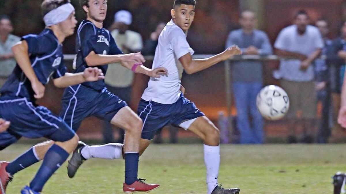 Smithfield-Selma’s Jhonny Verntura (4) and Cleveland’s Garrett Lee (left) and George Venturella (middle) chase a through ball late in the game.
