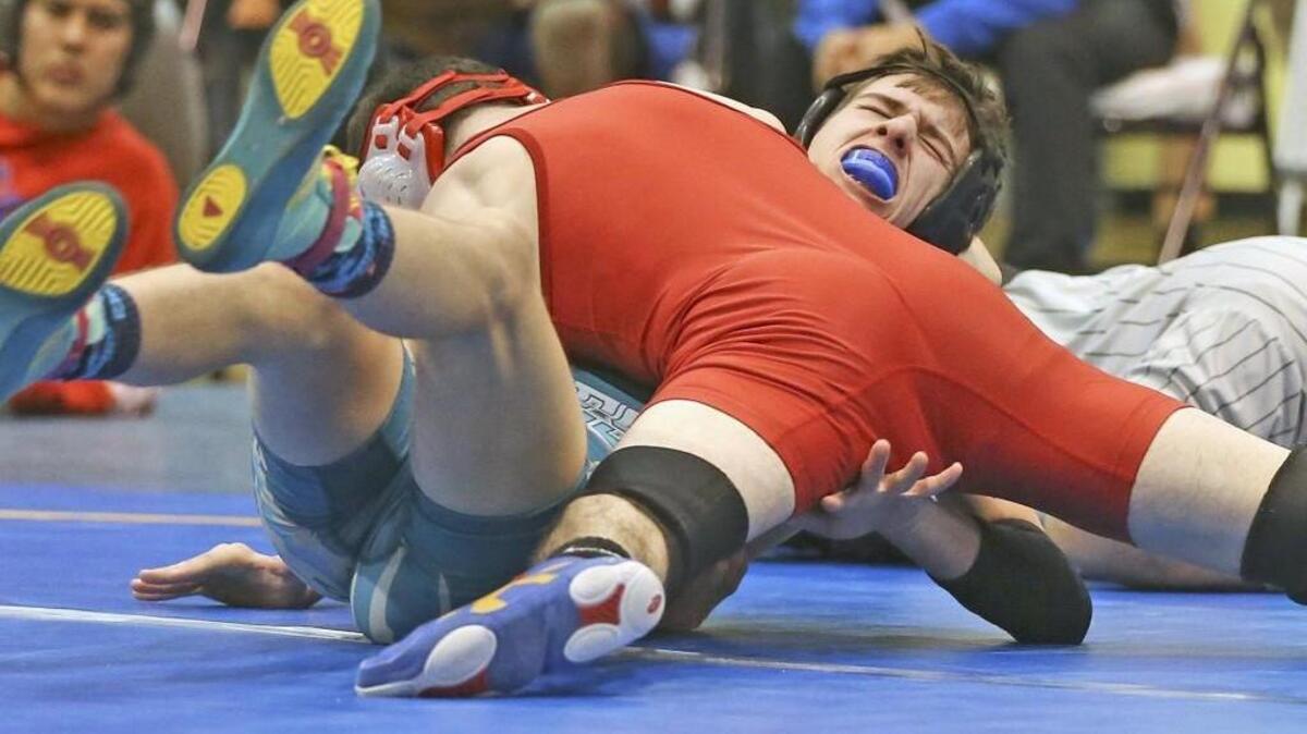West Johnston’s Austin Dailey grimaces as he tries to avoid the pin by Franklinton’s Daniel Mickshutz. Mickshutz win on to the win the 113-pound championship at the Jolly Roger Invitational at Corinth Holders High School on Saturday.