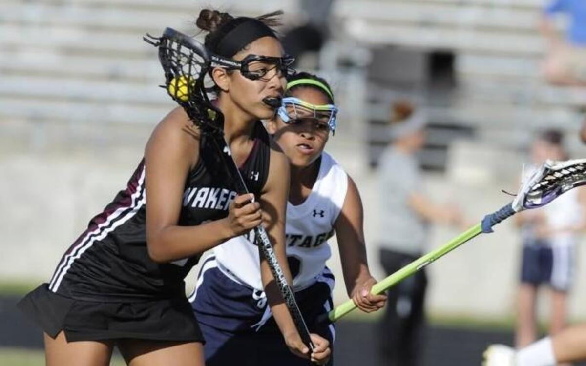 Wakefield's Andee Abrams (5) is pursued by Heritage's Susann Rivera (2) in Wake Forest, N.C. on Friday, April 15, 2016. Wakefield won 19-5.