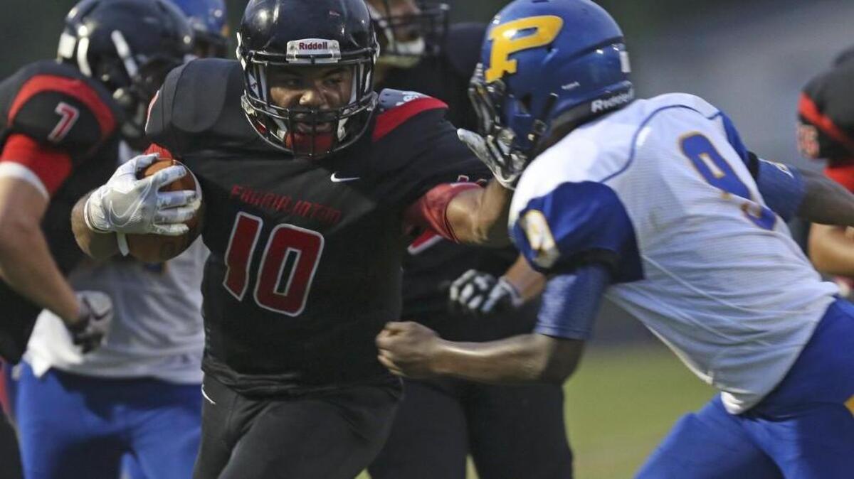 Franklinton's Tyreese Williams (10) breaks tackle number five as he stiff arms Princeton's Lamarr Wilkins (9) on his way to a 45 yard touchdown run late in the first quarter. Coverage from the prep football game between the Princeton Bulldogs and the Franklinton Red Rams played in Franklinton, N.C. on Thursday, September 1, 2016. Franklinton defeated Princeton 38-27..