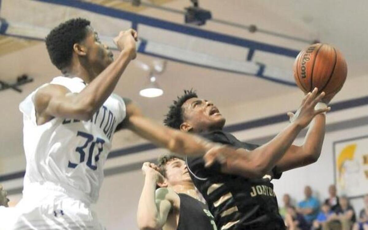 South Johnston’s Elijah Hill (4) drives to the basket against Clayton’s Austin Boyd (30) during Thursday’s game.