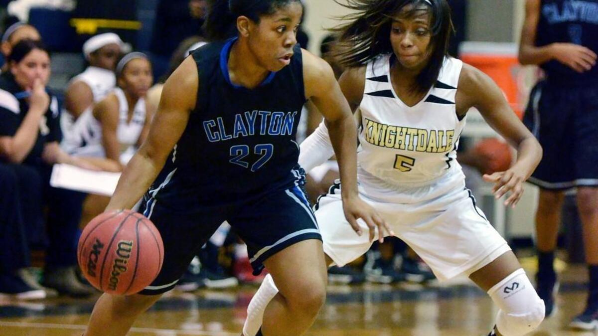 Clayton’s Au’Shonna Langley (22) drives against Knightdale’s Mikaya Wilson (5). The Clayton Comets took on the Knightdale Knights in a Greater Neuse River Conference girls basketball game in Knightdale, N.C. Tuesday, Dec. 15, 2015. The Knights won 78-50.