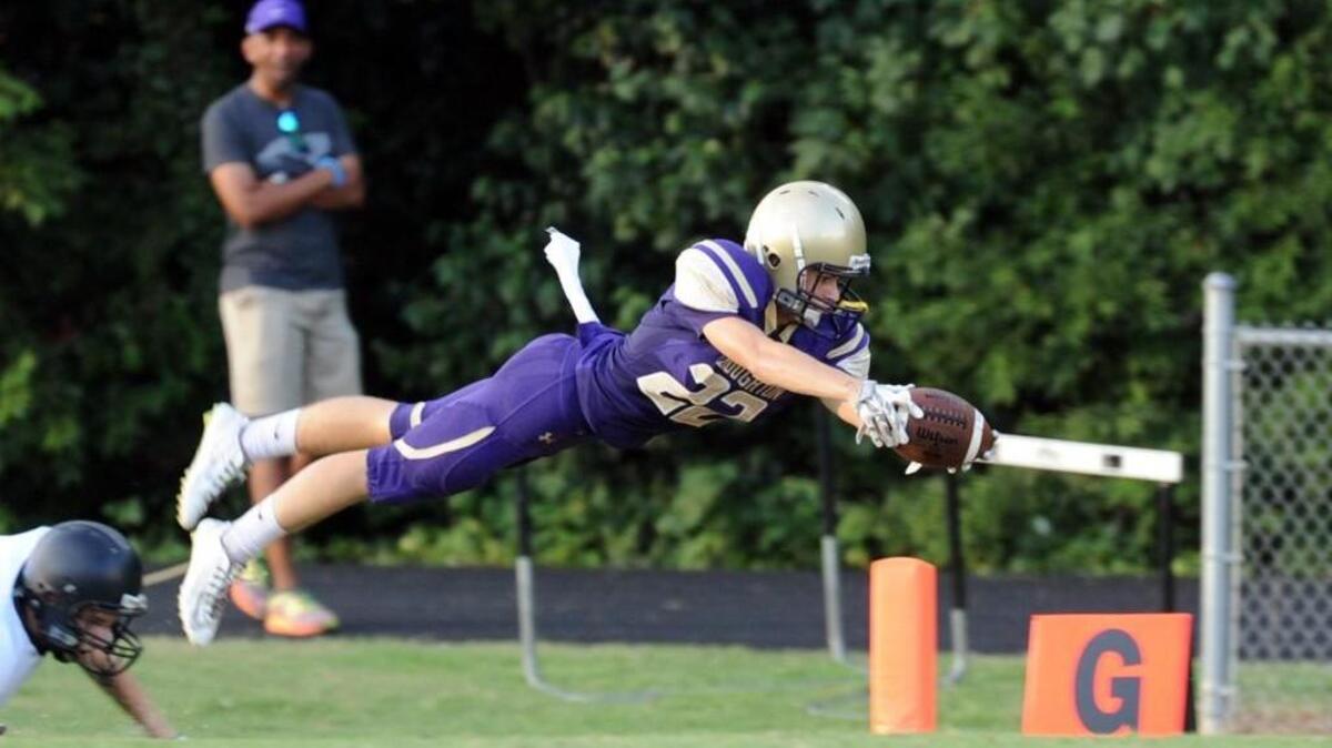 Broughton's Nick Cattano (22) dives for the goal line and lands just short during the football game, which was played in Raleigh on Friday, August 19, 2016.