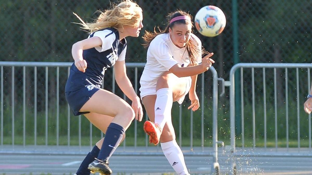 Alexa Wojnovich, right, of Carrboro finds a cross pass against the defense from Ida Greenlee, left, of First Flight. The Carrboro Jaguars played the First Flight Nighthawks in a girls soccer game that took place in Carrboro, N.C. on Tuesday, May 24, 2016. Carrboro won 5-0.