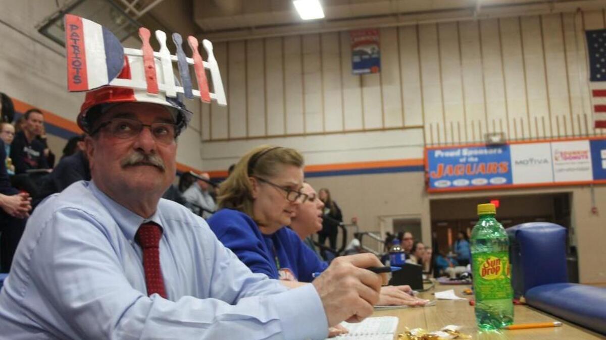David Ross, seen here on Feb. 8 in a game at Athens Drive wearing his red, white and blue “D-fence” hat, is in his first year assisting Apex Friendship’s girls basketball program after 18 years helping Apex High.