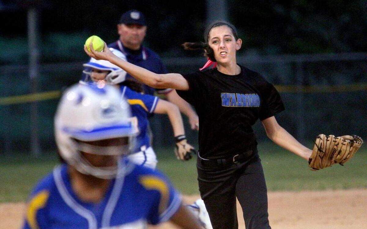 
East Wake's McKenzie Moore (13) throws home before Garner's Kira Jackson (2) crosses the home plate during the Garner High School softball game against East Wake High School, April 17, 2015 in Wendell, N.C. East Wake won 6-5.
