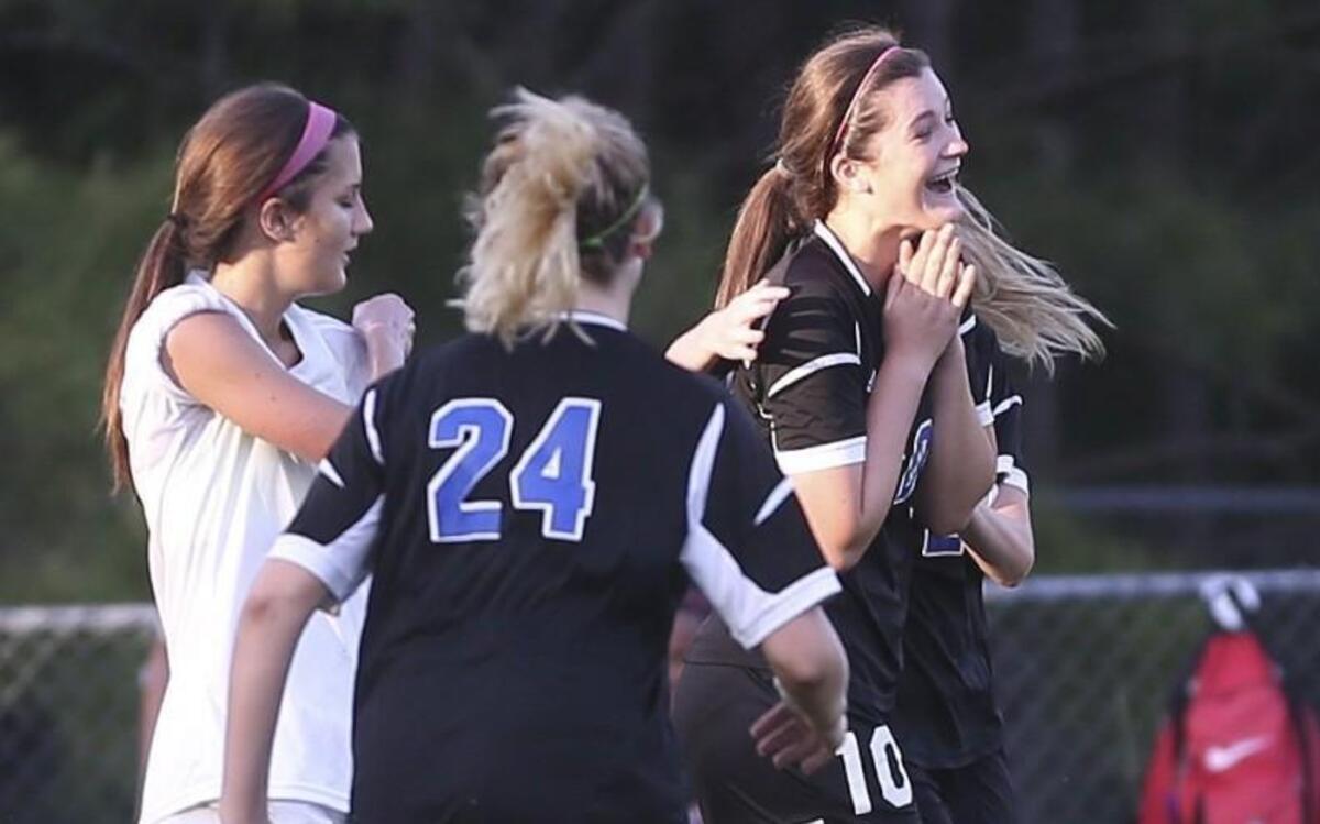 Clayton's Peyton Doyle (10) is mobbed by teammates after tying the game at 1-1 in the 31st minute of the game. Coverage from the girls soccer between the Clayton Comets and the West Johnston Wildcats played in Benson, N.C. on Wednesday, April 26, 2017. Clayton defeated West Johnston 3-2 in overtime to clinch the Greater Neuse River regular season championship.