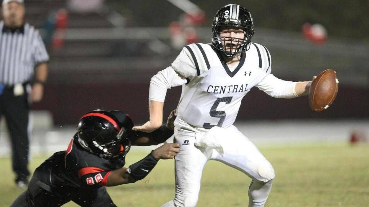 Granville Central's Jay Parker (5) dodges Franklinton's Ekwon White (88) at the line during the Granville Central High School football game against Franklinton High School, September,28, 2015 in , N.C. The score was 0-0 at the half.