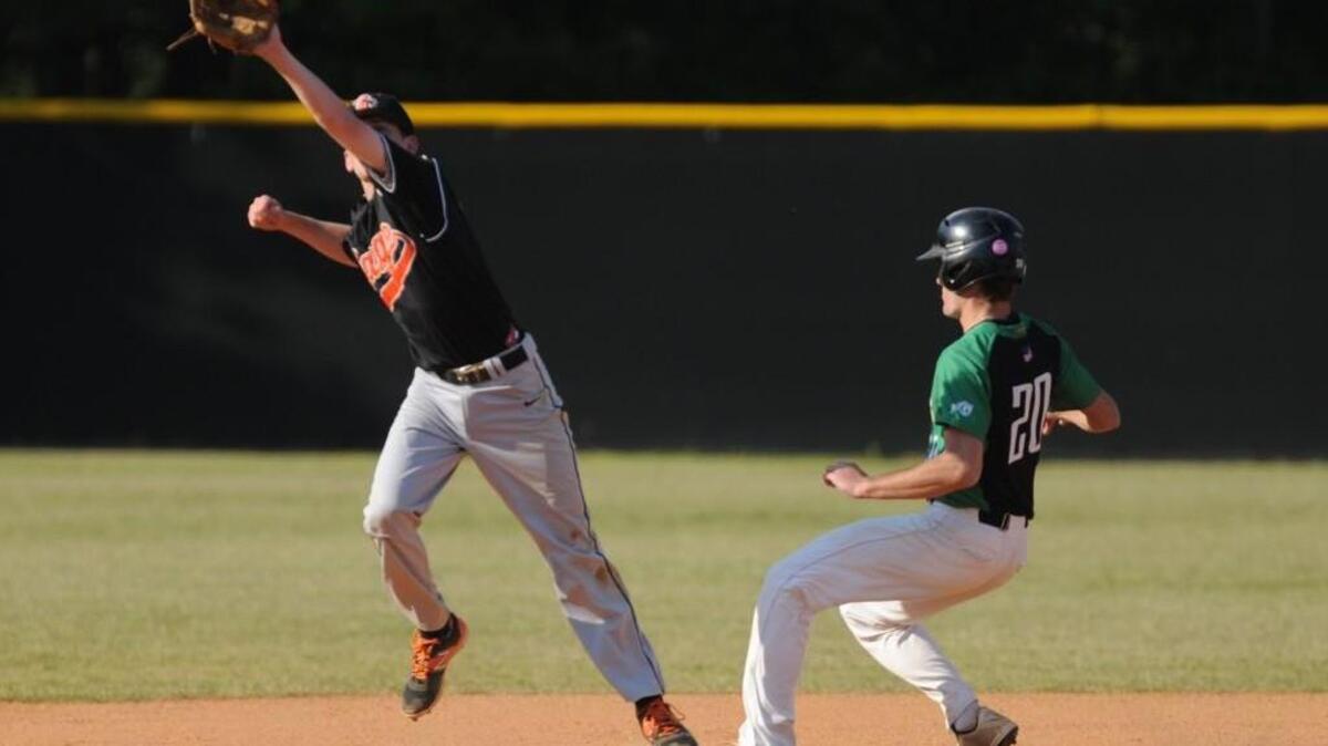 Cardinal Gibbons' Chris Thorburn (20) tags second base ahead of the throw to Orange's Cameron Mehl (left) during the baseball game, which was played in Raleigh on Wednesday, April 20, 2016. Cardinal Gibbons won 11-0.