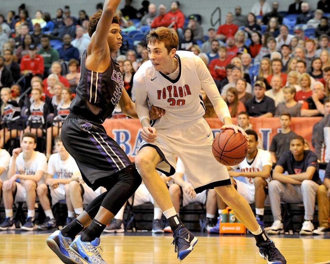 Voyager Academy's Jay Huff (30) drives to the basket while guarded by South Creek's James Moore (33). The Voyager Academy Vikings took on the South Creek Cougars in the NCHSAA Championship 1A East Boys Final in Crown Arena in Fayetteville, N.C. on March 5, 2016. Voyager Academy wins 71-50.