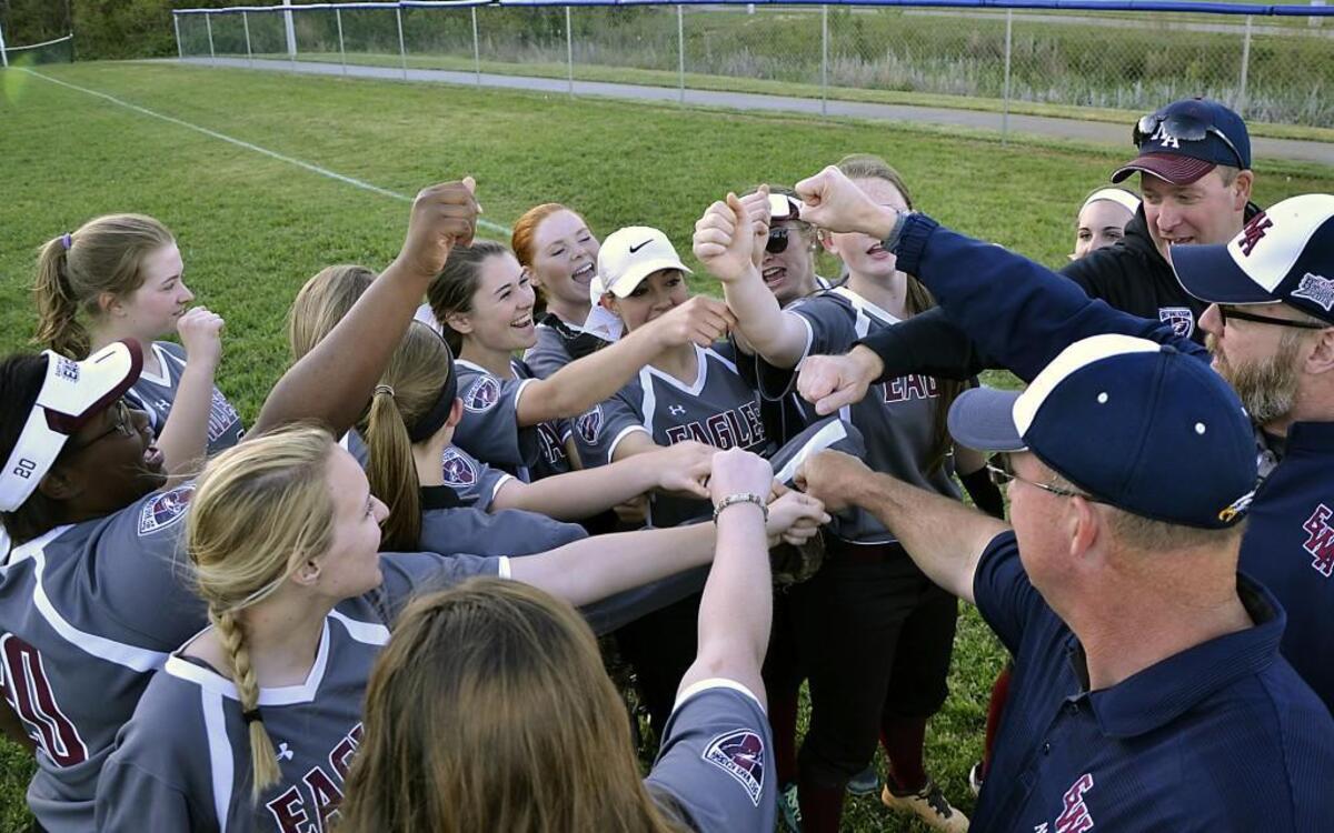 East Wake Academy softball players and coaches celebrate their win over Falls Lake Academy at Pilot Lions Park in the community of Pilot, N.C. Thursday, April 14, 2016.