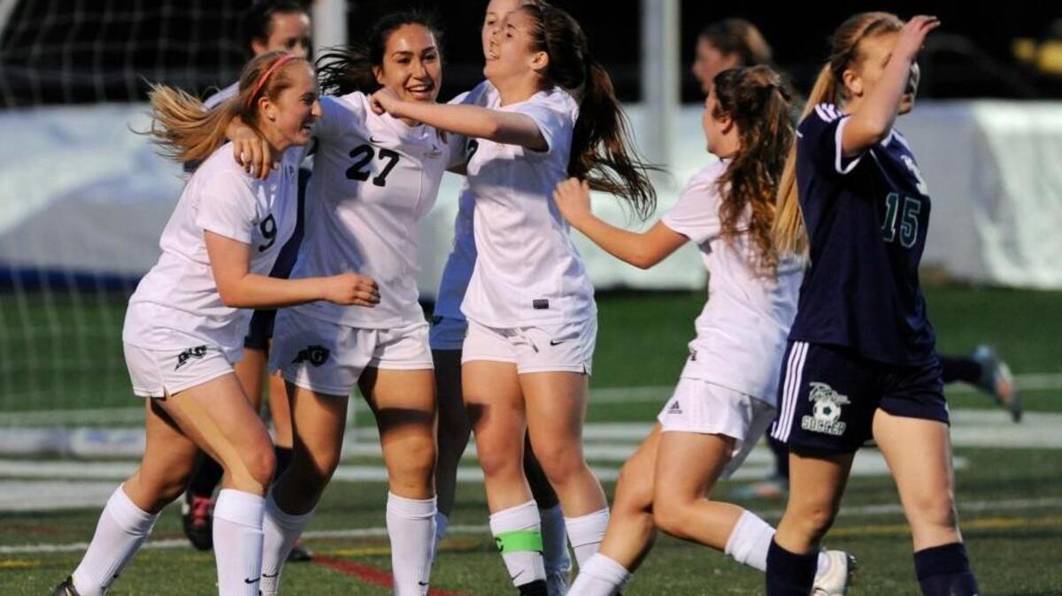 Cardinal Gibbons, seen here in 2015, is the N&O’s top-ranked area girls soccer team entering the playoffs. Cardinal Gibbons' Sami Tubolino (9) Camryn Guttierez (27) and Marissa Kowalski (17) celebrate after Guttierez scored a goal against Leesville Road in Raleigh on Thursday, April 2, 2015. Cardinal Gibbons won 1-0.