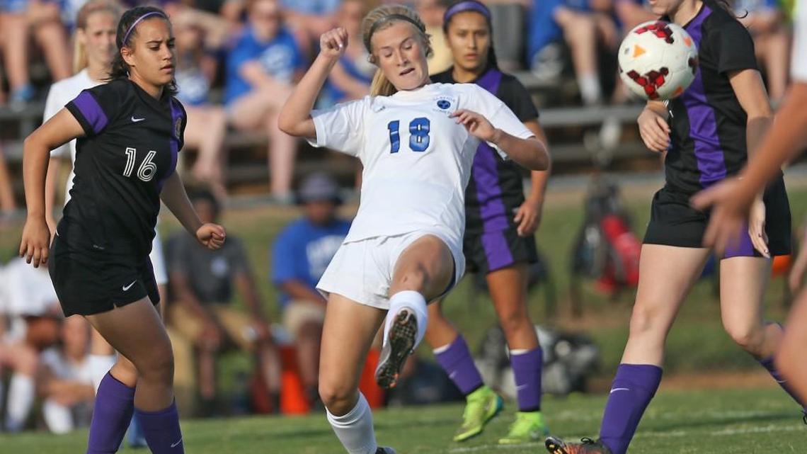 Clayton's Emery Biggs (18) sends the ball upfield as Jack Britt defenders Callie Creech (16) and Allison Shaw (2) converge on the play. Coverage from the 2nd round of the NCHSAA 4A soccer playoffs between the Clayton High Comets and the Jack Britt High Buccaneers played in Clayton, N.C. on Friday, May 13, 2016. Clayton defeated Jack Britt 3-1 to advance to the 3rd round of the playoffs.