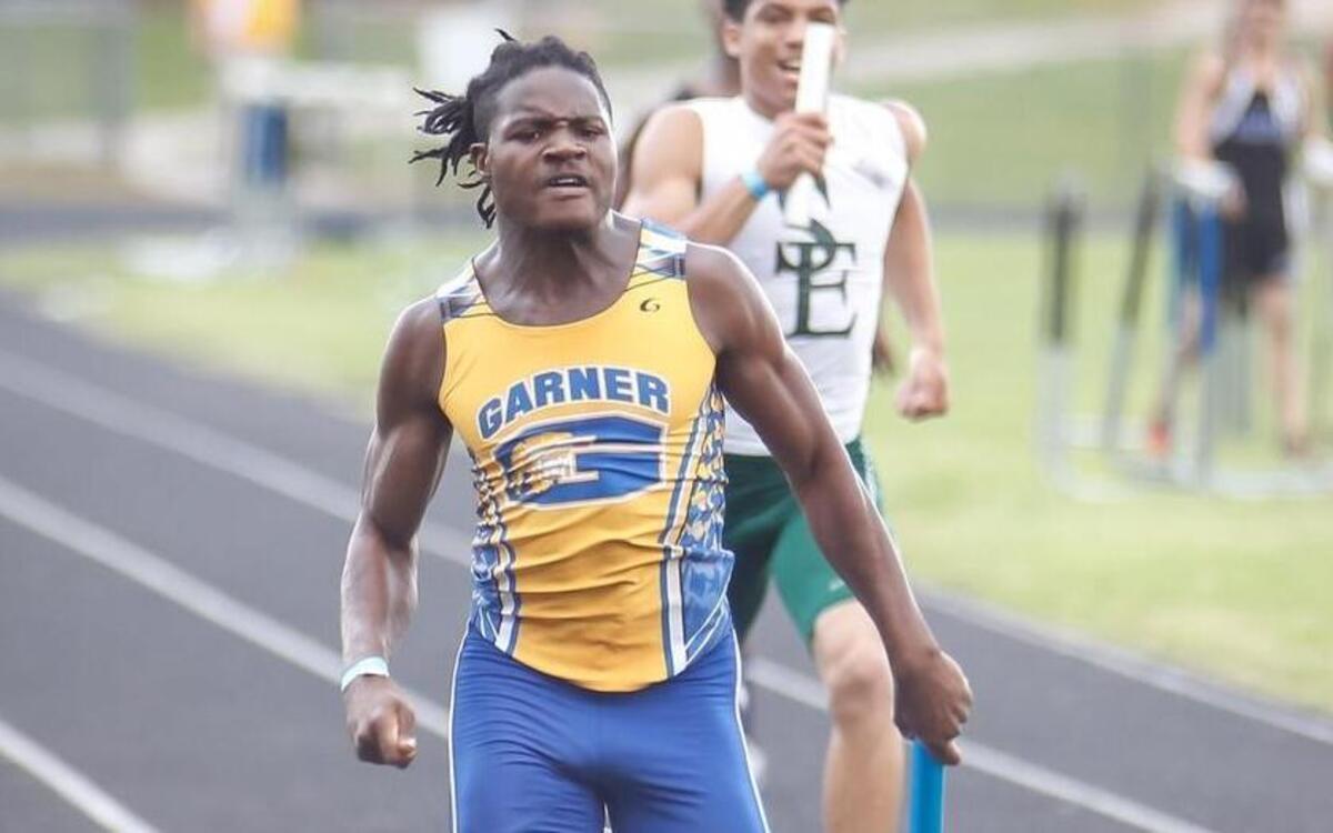Garner's R.J. Terry leads the pack on the final leg of the 4x200 meter relay as Southeast Raleigh's Travon Miller, right, takes second place during the GNRC conference championships at Garner on Monday, May 2, 2016.