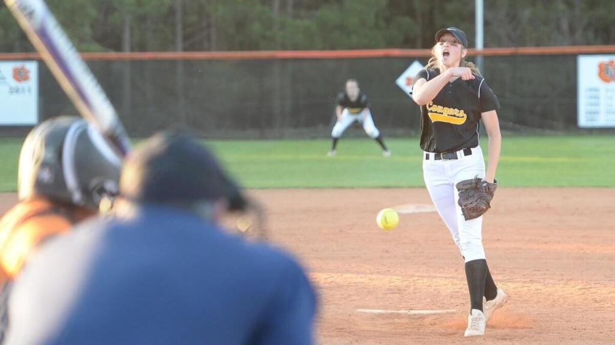 Julia Cerasi, right, of Apex throws a pitch for the Cougars. The Fuquay-Varina Bengals played the Apex Cougars in a softball game that took place in Apex, N.C. on Tuesday, March 15, 2016.
