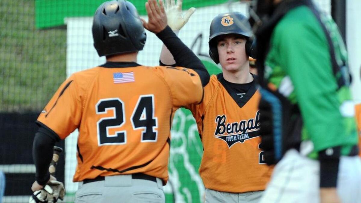 Fuquay-Varina high-fives after a run scored during the baseball game against Cary, which was played in Cary on Tuesday, April 5, 2016. Fuquay-Varina won 16-4.
