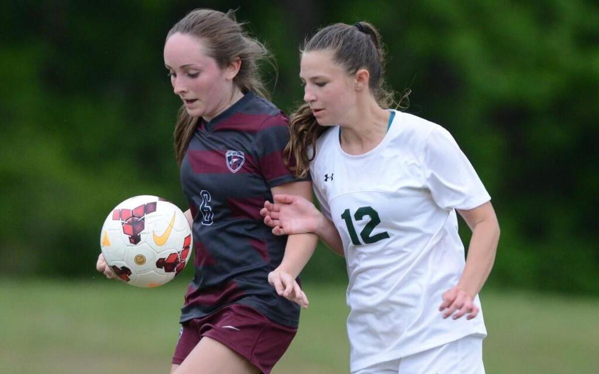 Savannah Smith (6) of East Wake Academy wins control of the ball against Eden Hart (12) of Woods Charter. The Woods Charter Wolves played the East Wake Academy Eagles in a girls soccer game that took place in Chapel Hill, N.C. on Monday, May 1 2017. Woods Charter won 3-0.