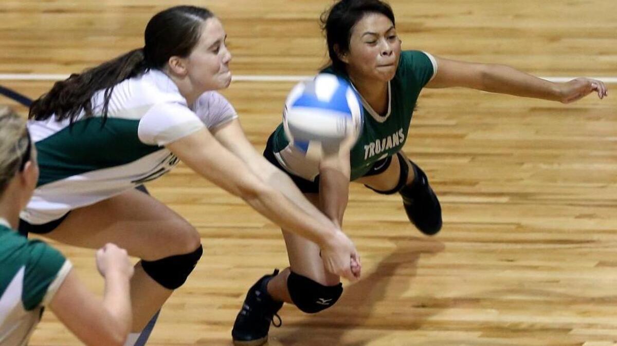 
South Johnston's Reagan Byrd (left) and Selena Flores converge to return a Cleveland shot in the middle of the court. Coverage from the high school volleyball game between the Cleveland Rams and the South Johnston Trojans played in Clayton, N.C. on Thursday, September 17, 2015. South Johnston won 3-0.
