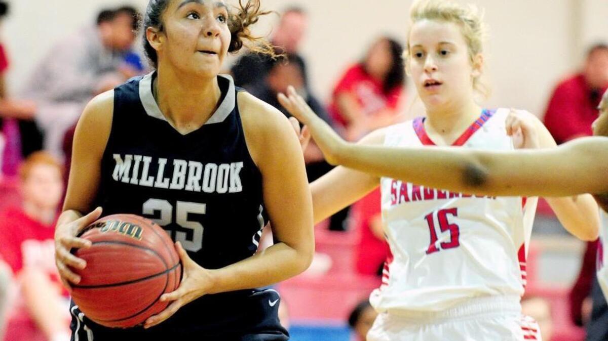 Millbrook's Sis Norman (25) drives past Sanderson's Lauren Prakke (15) during the girls basketball game, which was played in Raleigh on Friday, February 10, 2017. Millbrook won 72-28.