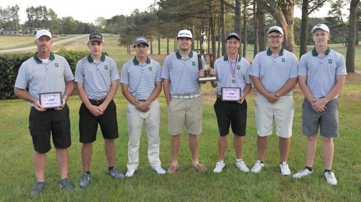 Members of South Johnston’s boys golf team (from left) Coach Daniel Benson, Cameron Wallace, Casey Charbonneau, Brooks Skinner, Patrick Stephenson, Jordan Barbour and Cameron McMullen pose after winning the Two Rivers 3A Conference championship. It’s the Trojans’ first team boys golf championship in school history.