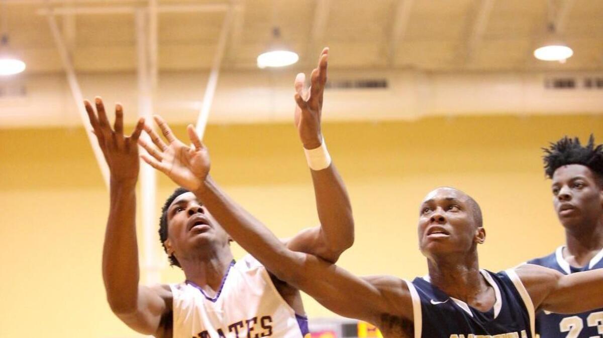 Johnavan Neal (22) of Corinth Holders fights for a rebound against Smithfield-Selma’s Rashad Potts (20).