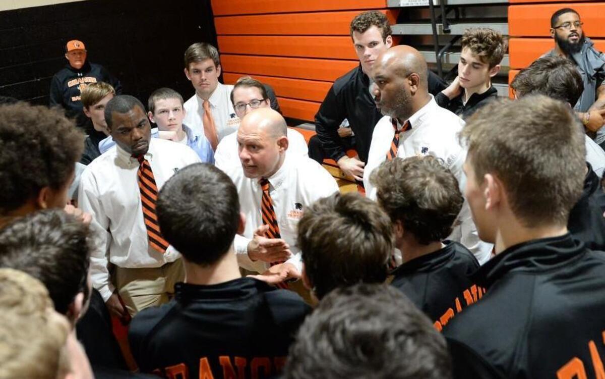 Bobby Shriner, center, head coach of Orange, speaks to his team at the end of the match. The dual team wrestling match between the Orange Panthers and the Chapel Hill Tigers took place in Hillsborough, N.C. on Thursday, January 26, 2017. Orange won 42-27.