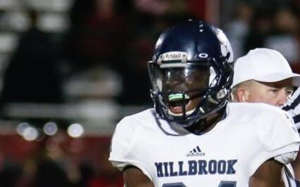 Millbrook running back Larry Roundtree celebrates a successful pass he completed on a trick play during Millbrook's playoff football game at Middle Creek on Friday, November 20, 2015.