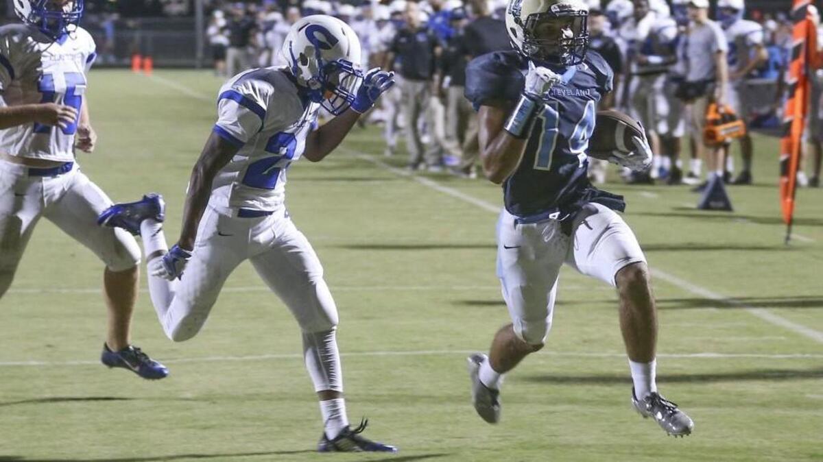 Cleveland's Jacob Scott (14) gets by Clayton defender Macaleb Robertson (2) to score. Coverage from the prep football game between the Clayton Comets and the Cleveland Rams played in Clayton, N.C. on Friday, August 19, 2016. Cleveland lead Clayton with 7 minutes to go in game 56-41 before a lightning delay.