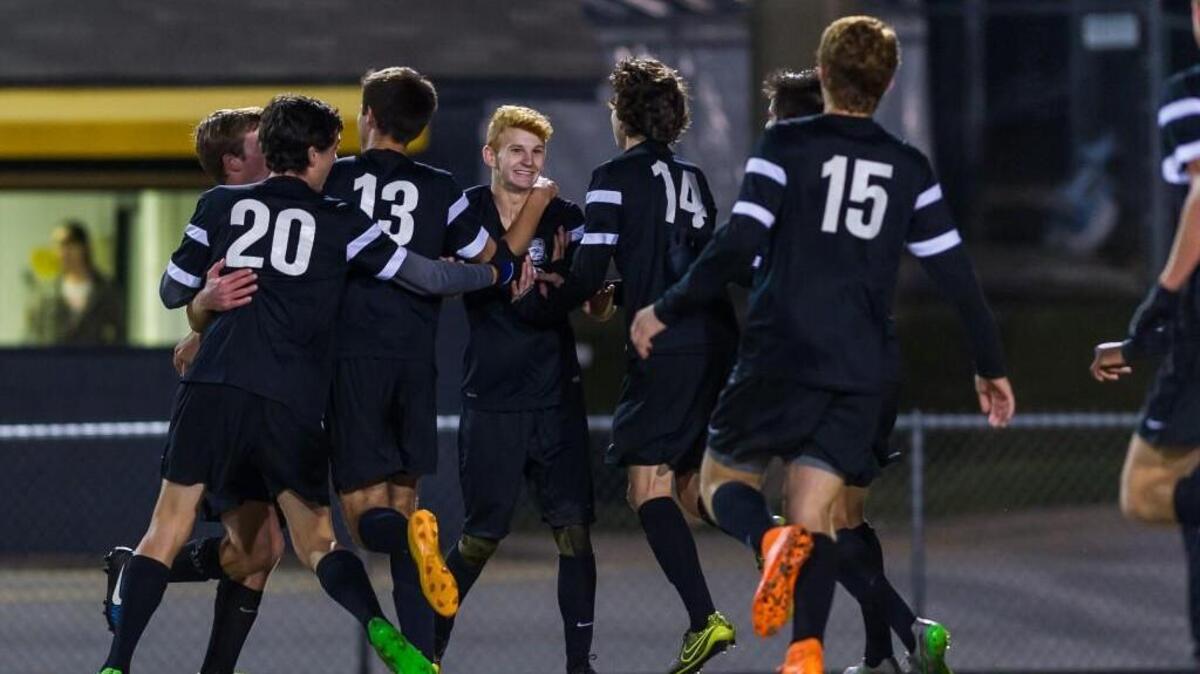 
The Green Hope Falcons celebrate Parker Washburn's (4) game-tying goal as the Green Hope High School Falcons defeated the Apex High School Cougars 3-2 at Cougar Stadium at Apex High School on Monday, October 19
