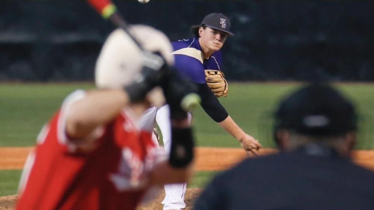 Holly Springs' Jake Isbell pitches to Middle Creek's John D'ercole (26) during Middle Creek's baseball game at Holly Springs on Tuesday, March 15, 2016. Holly Springs won the game 7-0 on the strength of Isbell's one-hit performance.
