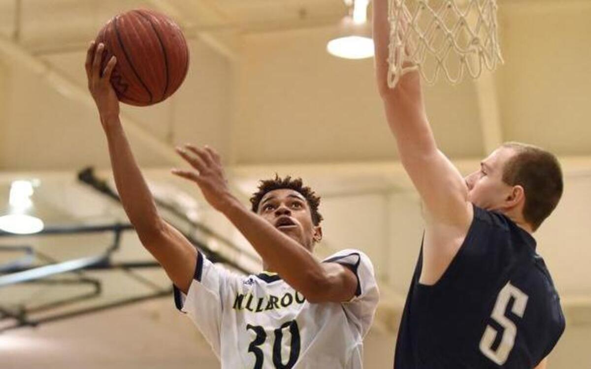 Millbrook's Trejon Jacob (30) shoots over Heritage's Ian Hinkley (5) in Raleigh, N.C. on Friday, February 5, 2016. Millbrook won 64-58.