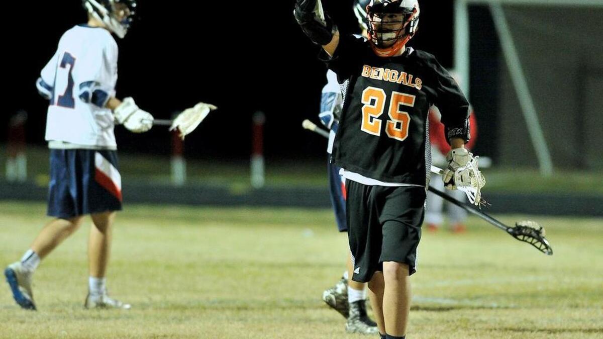 Fuquay-Varina's Max Quinn (25) celebrates after scoring a goal. The Fuquay-Varina Bengals took on the Apex Friendship Patriots in lacrosse in Apex, N.C. on March 8, 2016. Fuquay-Varina won 8-5.