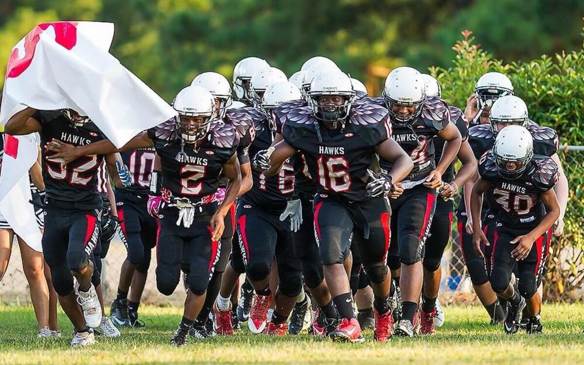 
Kestrel Height's Denzel Allen (16) leads the team on the field before the 3-0 Hawks’ 50-6 victory over South Wake Homeschool on August 28.
