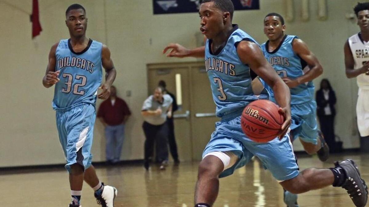 West Johnston’s Ryan Holmes (3) drives to the basket as teammate Jalen Langley (32) and Jason Bryant (23) trail the play.