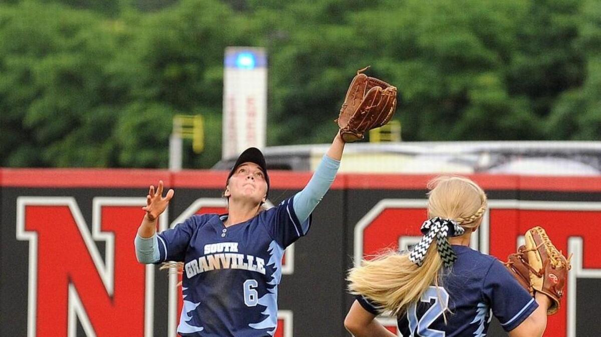 South Granville's Savannah Tilley (6) catches a fly ball as Erin Boone gives her room during the NCHSAA 2A girls softball championships between the South Granville Vikings and the Forbush Facons, which was played at the NCSU Softball Complex in Raleigh, on Friday, June 5, 2015. South Granville won 2-1 in overtime.