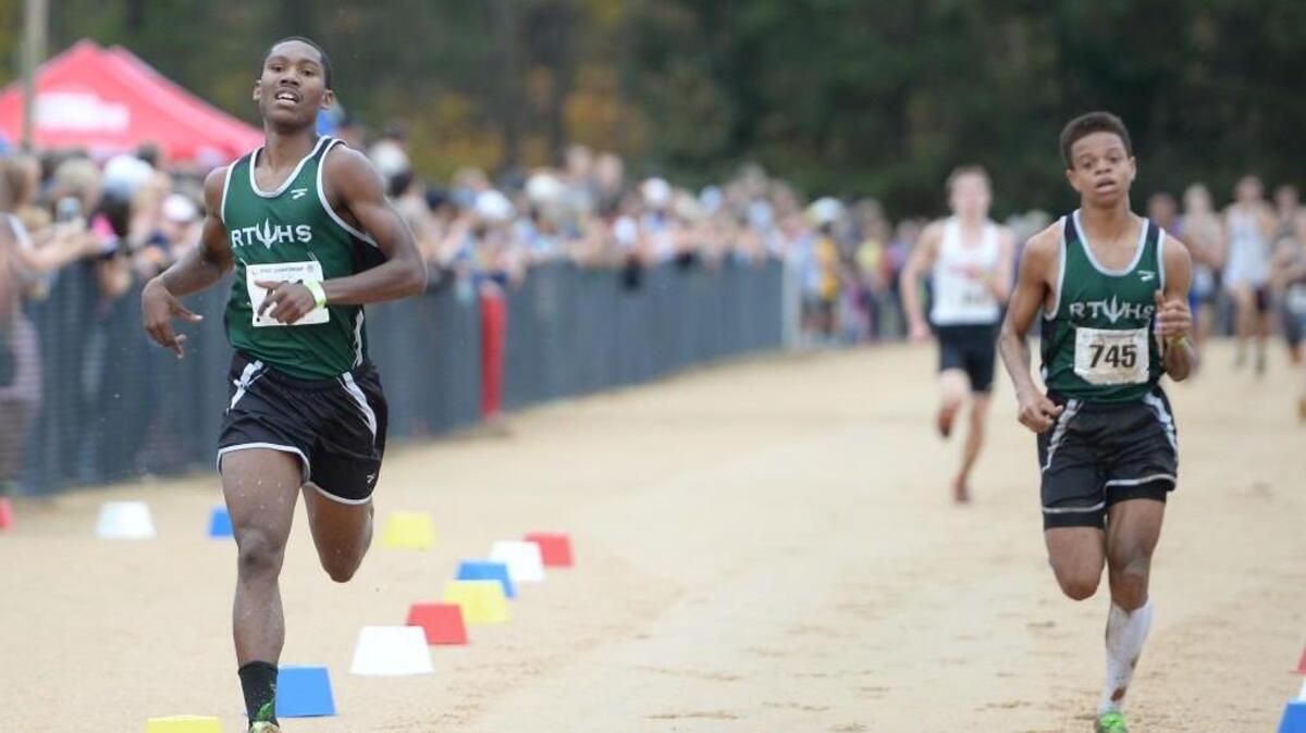 Madison Daniel, left, and Michal Swepson of Research Triangle cross the finish line during the 1A NCHSAA Cross Country Championships that took place at the Ivey M. Redmon Sports Complex in Kernersville, N.C. on Saturday, November 7, 2015.