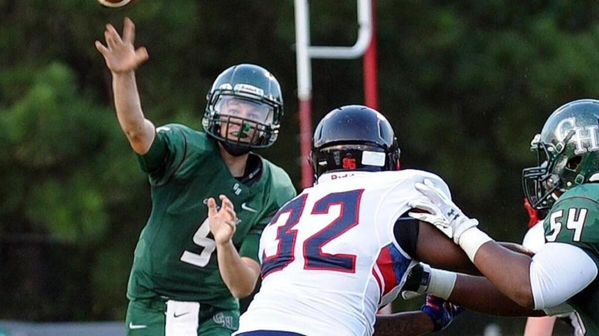 Green Hope quarterback Willie Taylor (5) passes through the defense of Jordan's Billy Baines (32) during the football game, which was played in Cary on Friday, August 26, 2016.