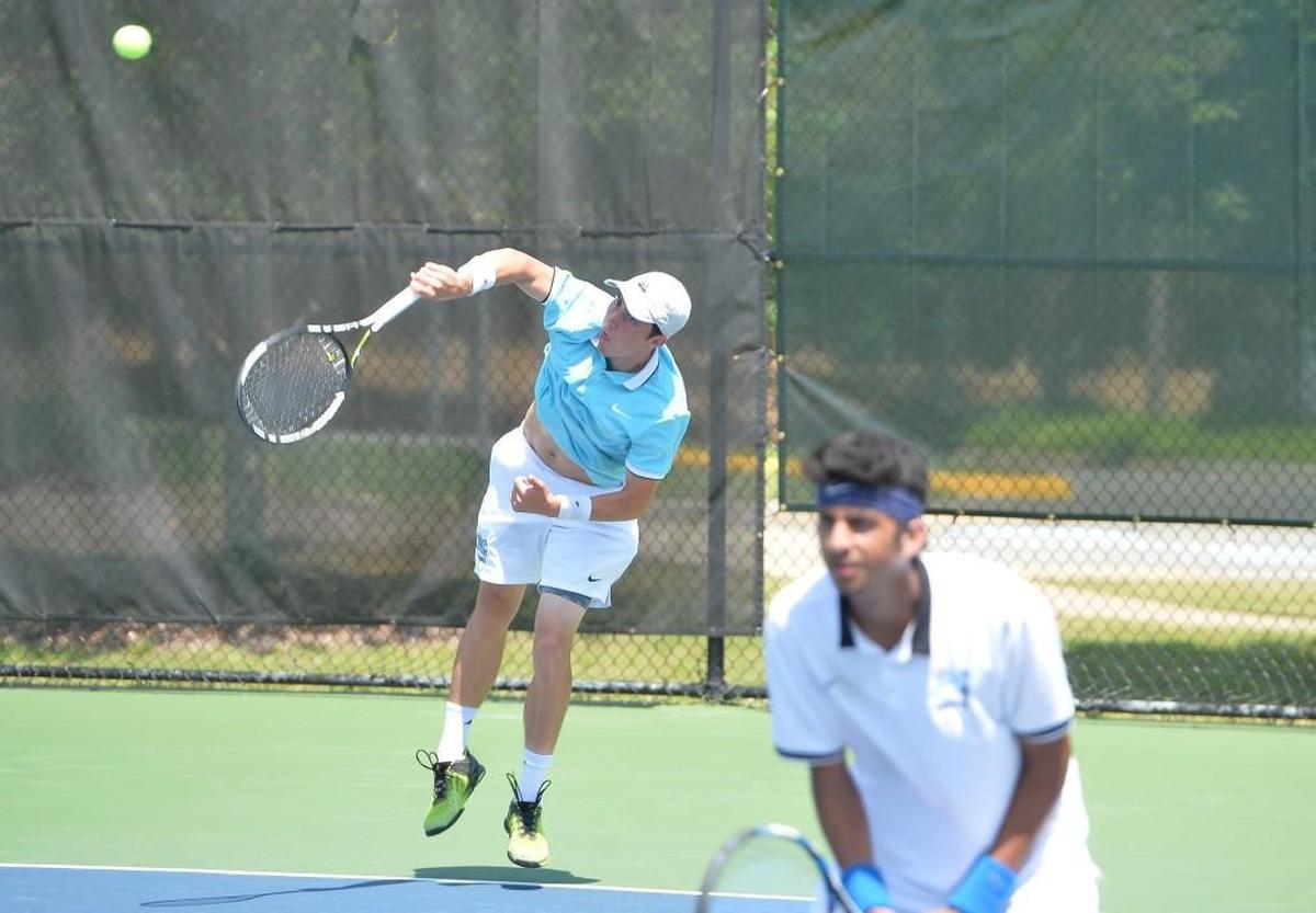 Trice Pickens, left, of Panther Creek serves the ball along his teammate Siddhant Pal, right, during their doubles match against Mark Dillon and Sam Dean of Myers Park. The Panther Creek Catamounts played the Myers Park Mustangs in a boys tennis match that took place in Burlington, N.C. on Saturday, May 20 2017. Myers Park won 5-4.