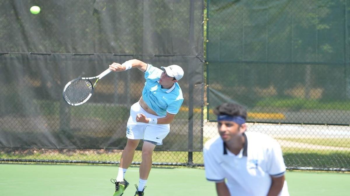 Trice Pickens, left, of Panther Creek serves the ball along his teammate Siddhant Pal, right, during their doubles match against Mark Dillon and Sam Dean of Myers Park. The Panther Creek Catamounts played the Myers Park Mustangs in a boys tennis match that took place in Burlington, N.C. on Saturday, May 20 2017. Myers Park won 5-4.